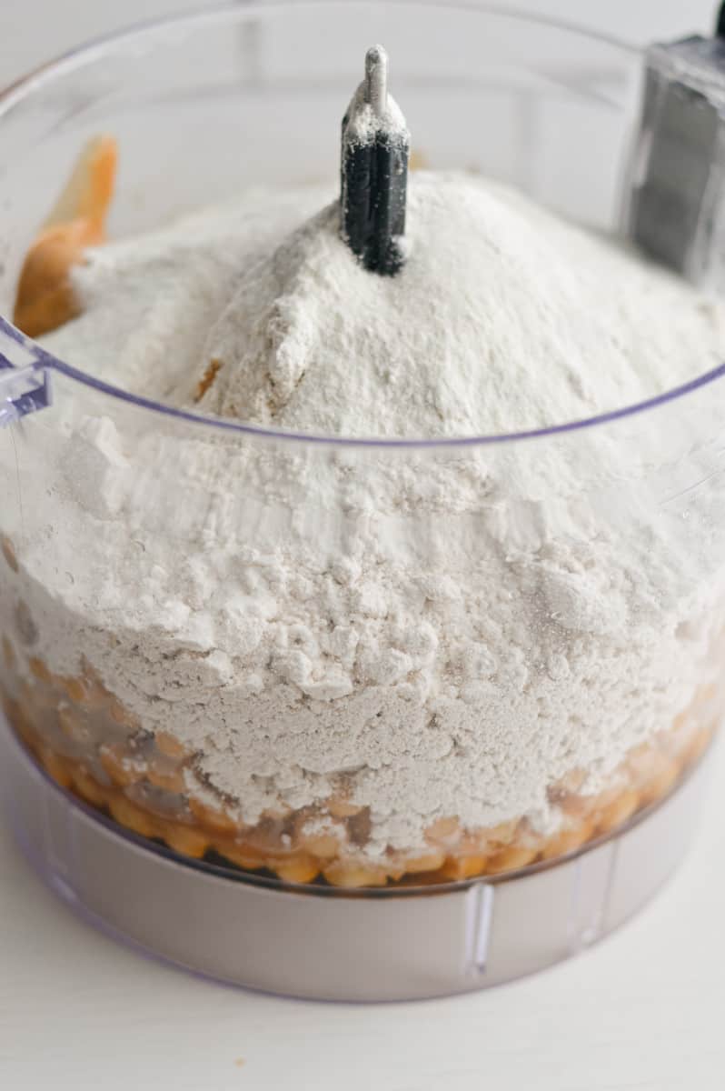 Adding ingredients to food processor.