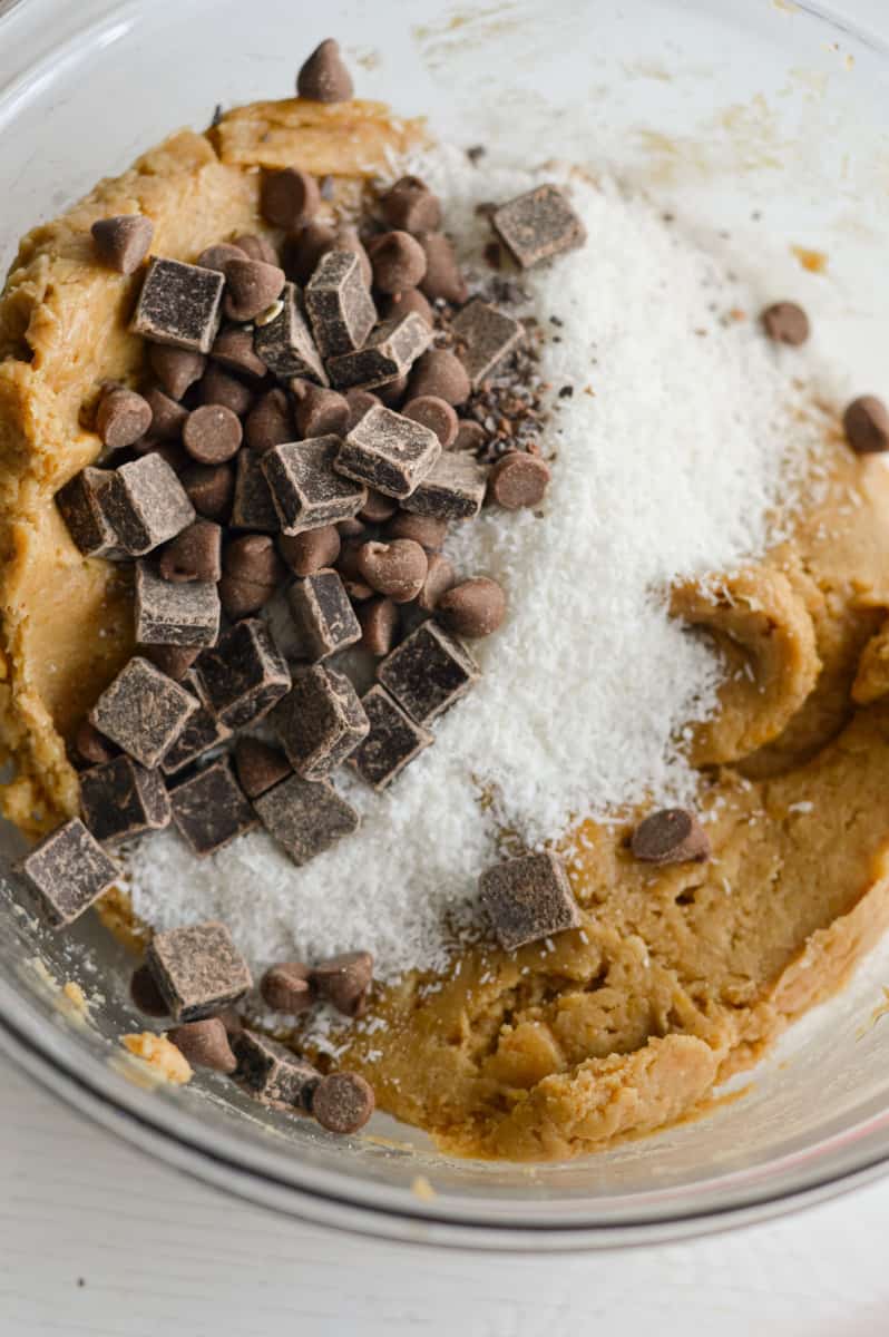 Adding chocolate chunks and mix-ins to chickpea cookie dough.