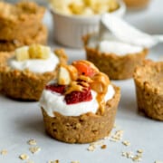 Granola cup filled with yogurt, fruit and peanut butter.