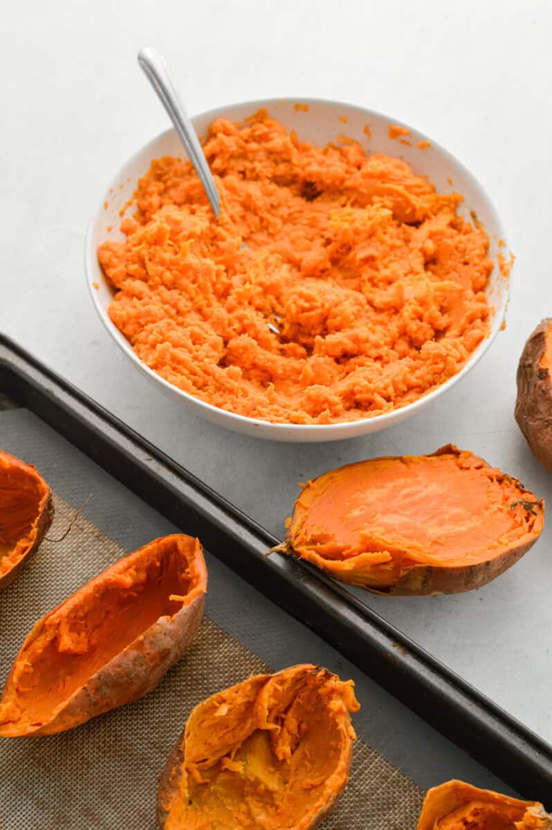Mashing sweet potatoes.