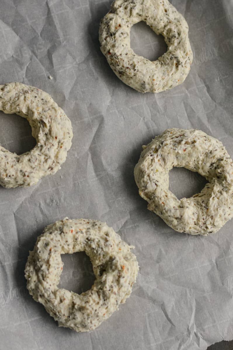 Shaping bagels on a tray.