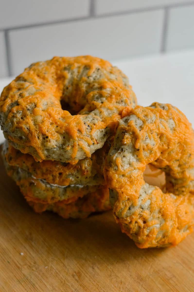 Stack of herb and cheddar greek yogurt bagels.
