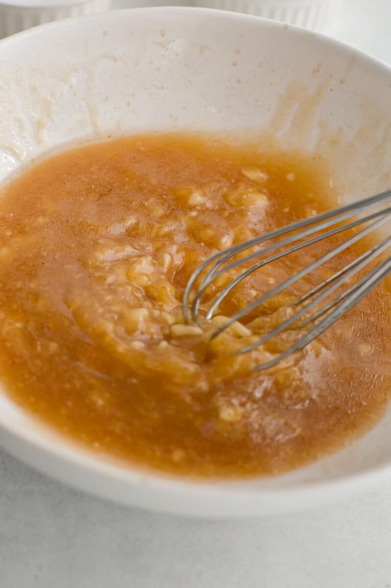 Mixing together butter, honey, vanilla and banana until smooth and well-blended.