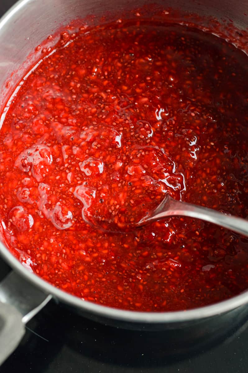 Adding chia seeds to raspberries.