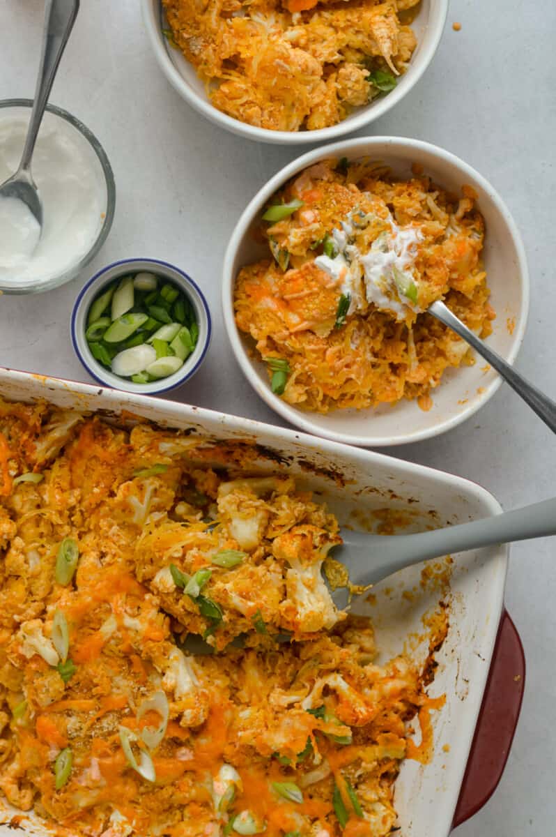 Serving bowls of buffalo chicken spaghetti squash casserole.