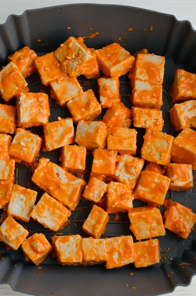 Cooking buffalo tofu in the air fryer.