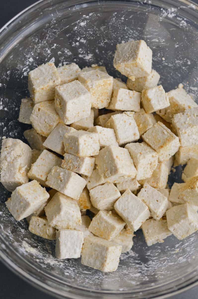 Coating tofu with cornstarch.