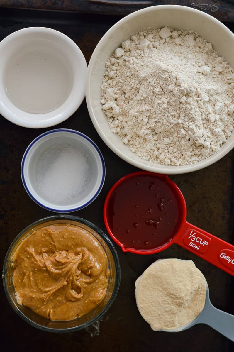 Ingredients for perfect bar recipe including oat flour, peanut butter, honey, protein powder and salt.