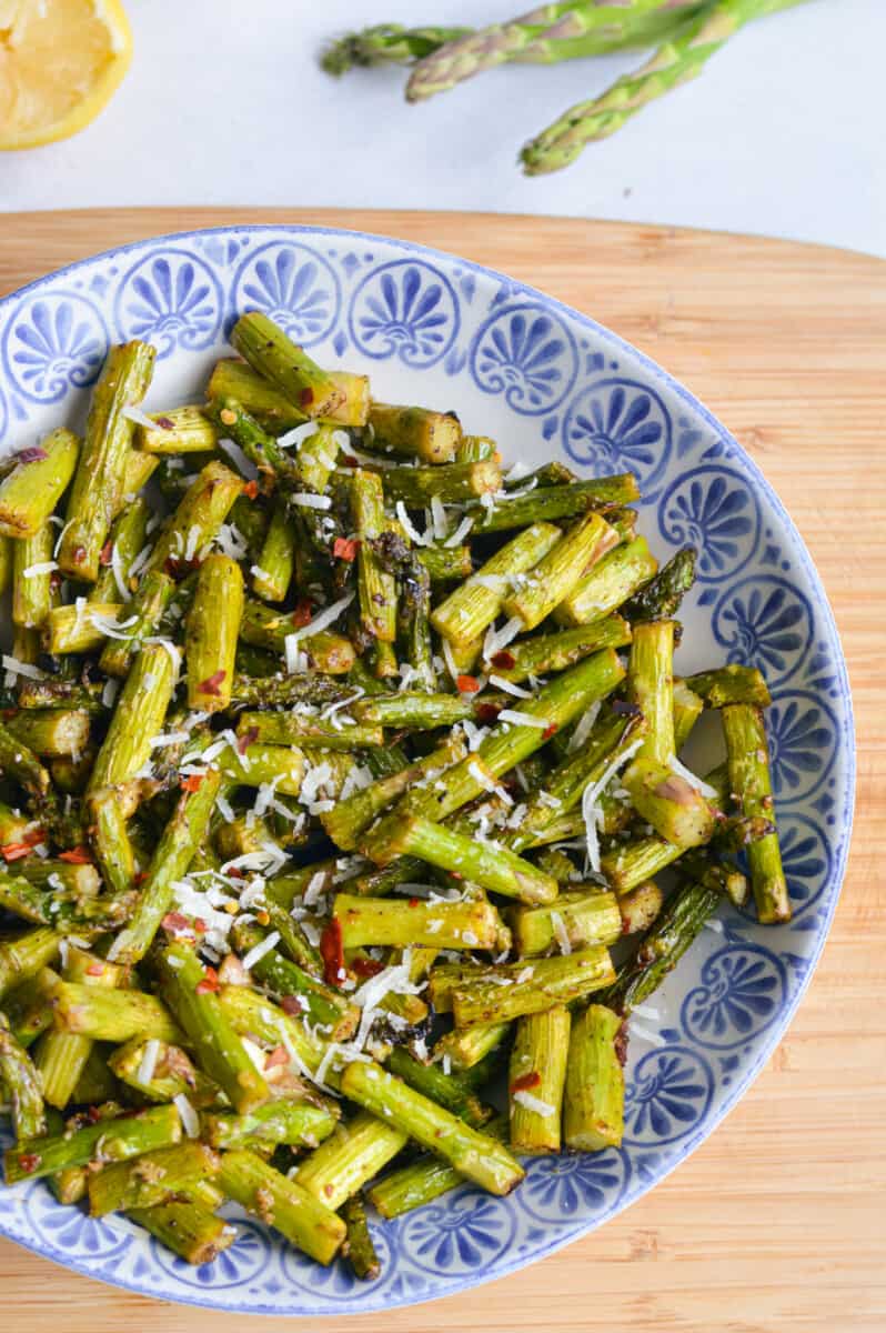 Birds eye of blue bowl with spicy parmesan asparagus.