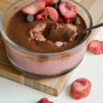 Jar of strawberry blended overnight oats with a chocolate magic shell.