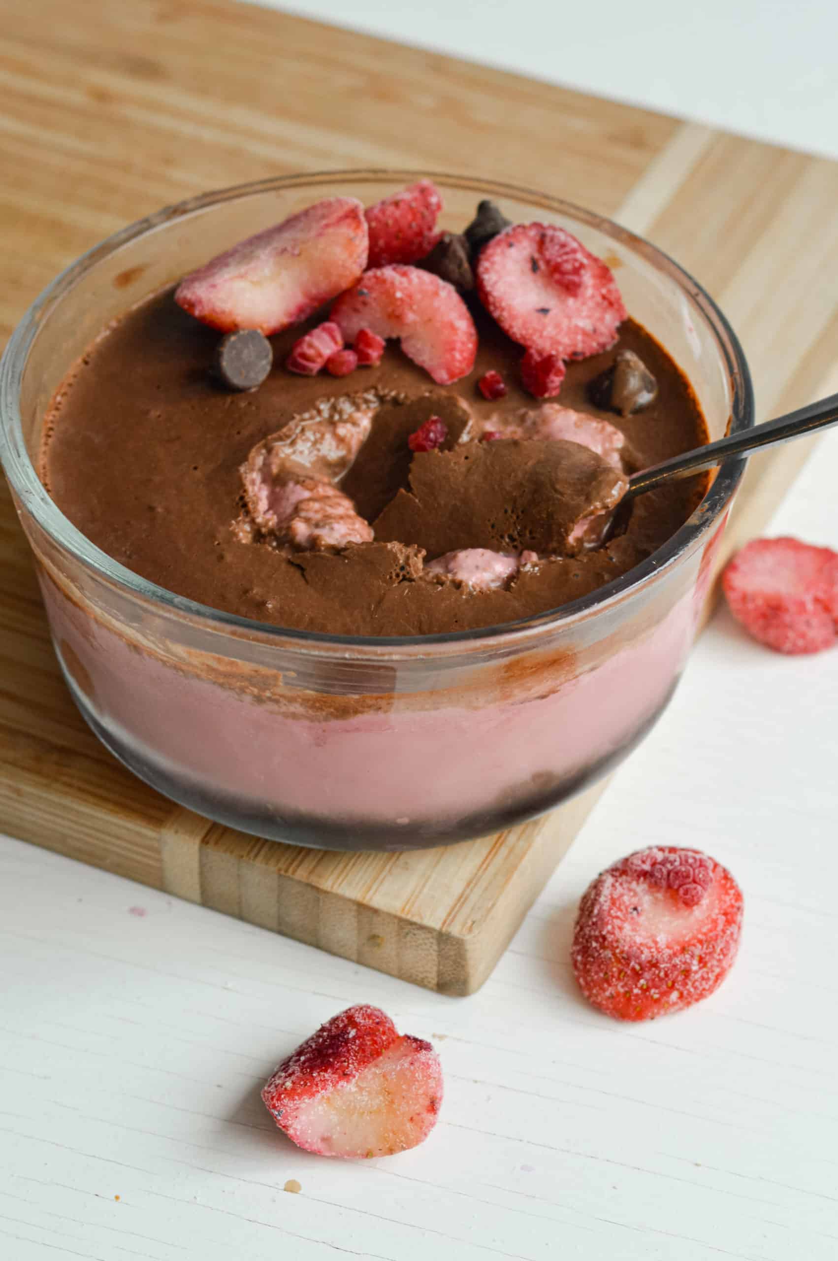 Jar of strawberry blended overnight oats with a chocolate magic shell.