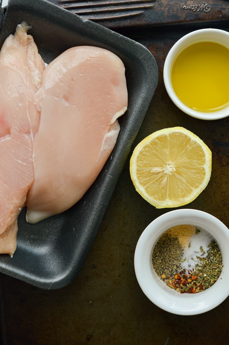 Baking chicken breasts in the oven with olive oil, lemon and spices.