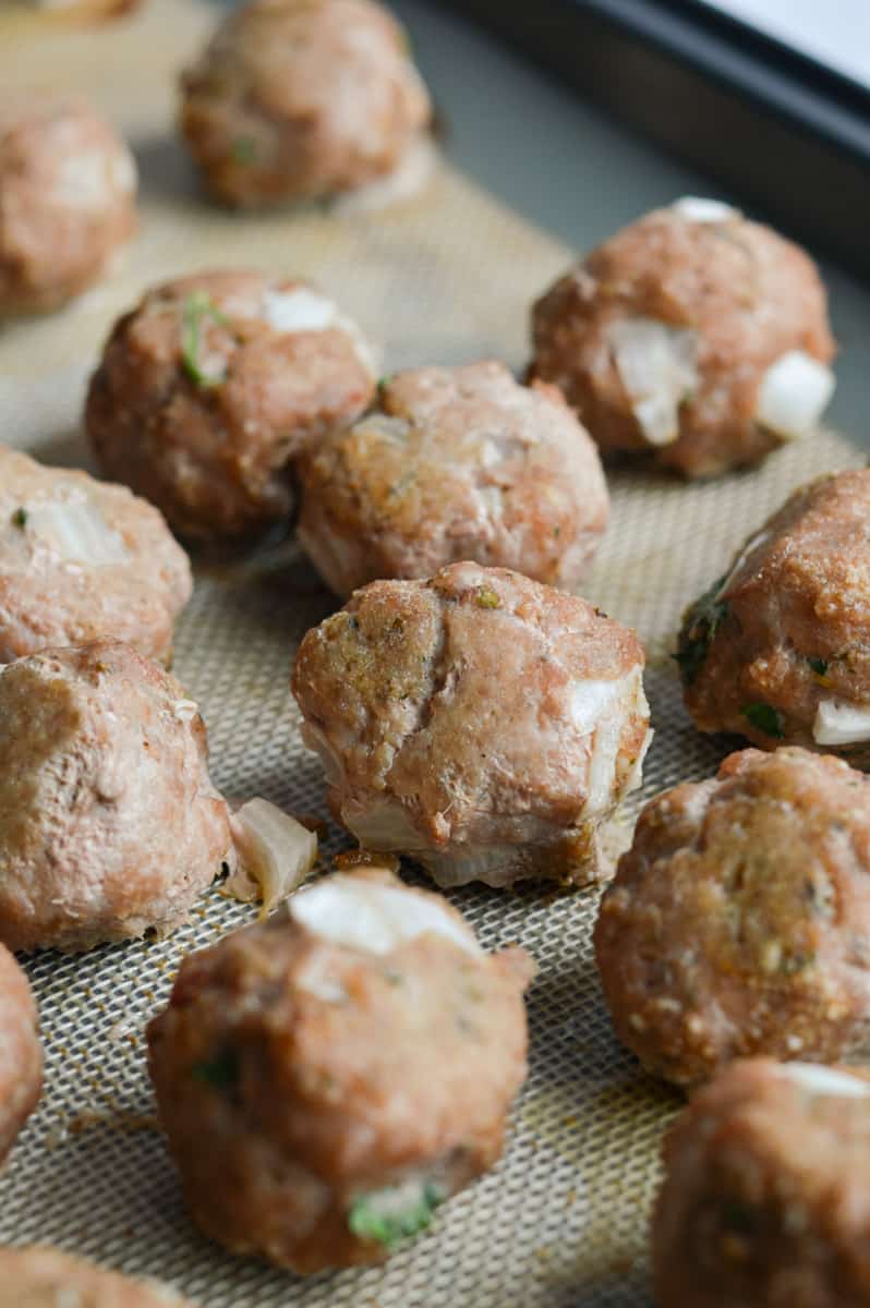Cooked turkey feta meatballs on a tray.