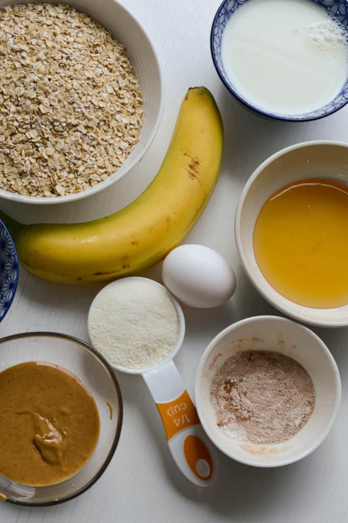 Ingredients including oats, banana, collagen, milk, chocolate chips, egg and peanut butter.