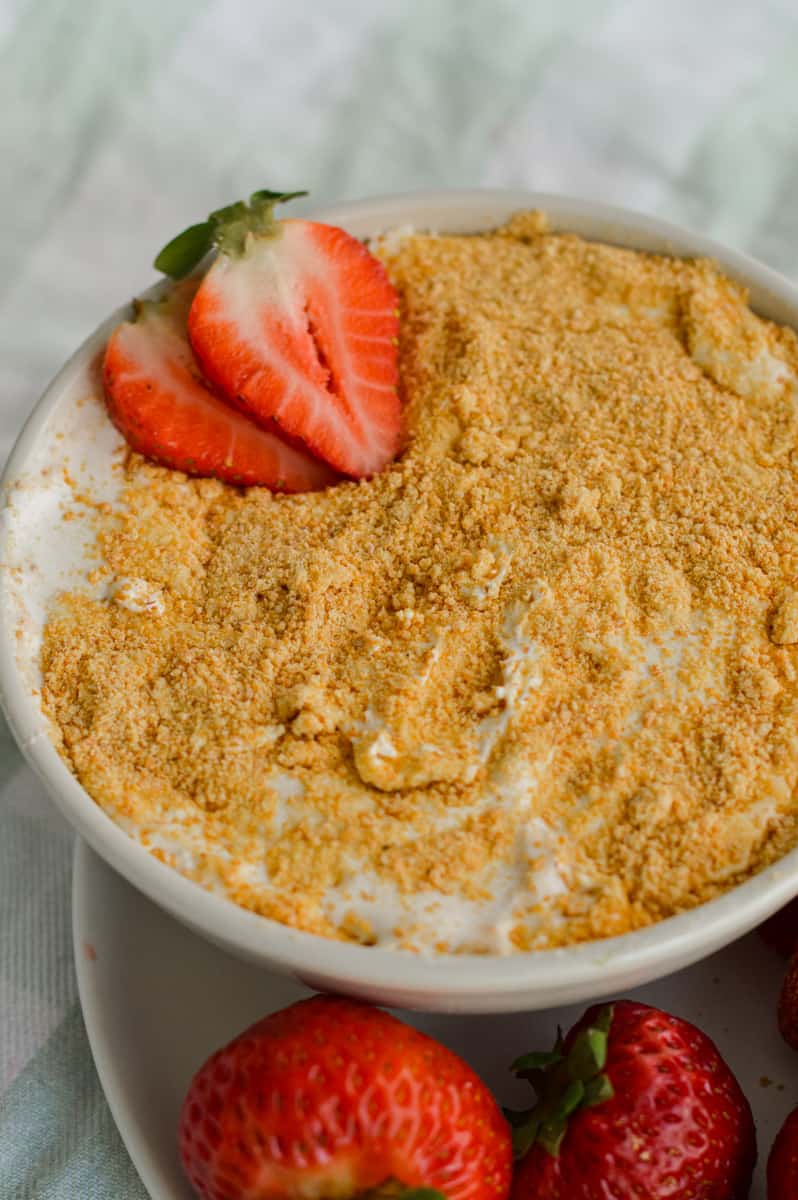 Fruit cheesecake dip topped with strawberries.