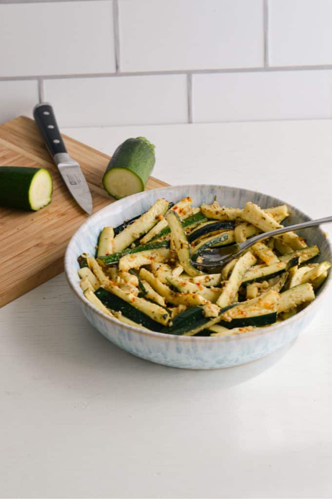 Lemon parmesan zucchini sticks in a bowl.