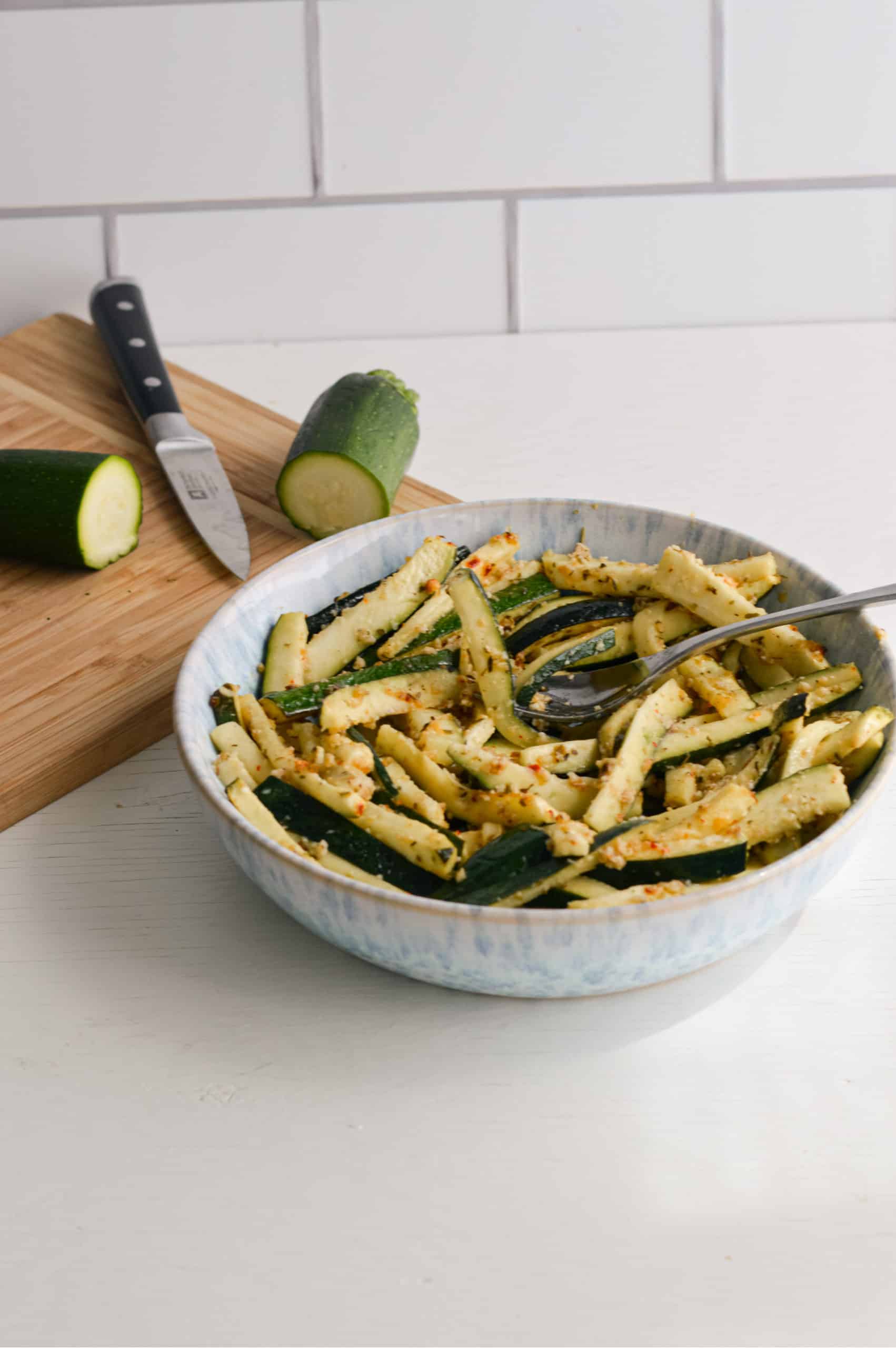 Lemon parmesan zucchini sticks in a bowl.
