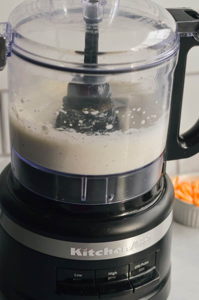 Blending cottage cheese dip in a food processor.