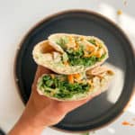 Kale caesar chicken wrap cut in half.