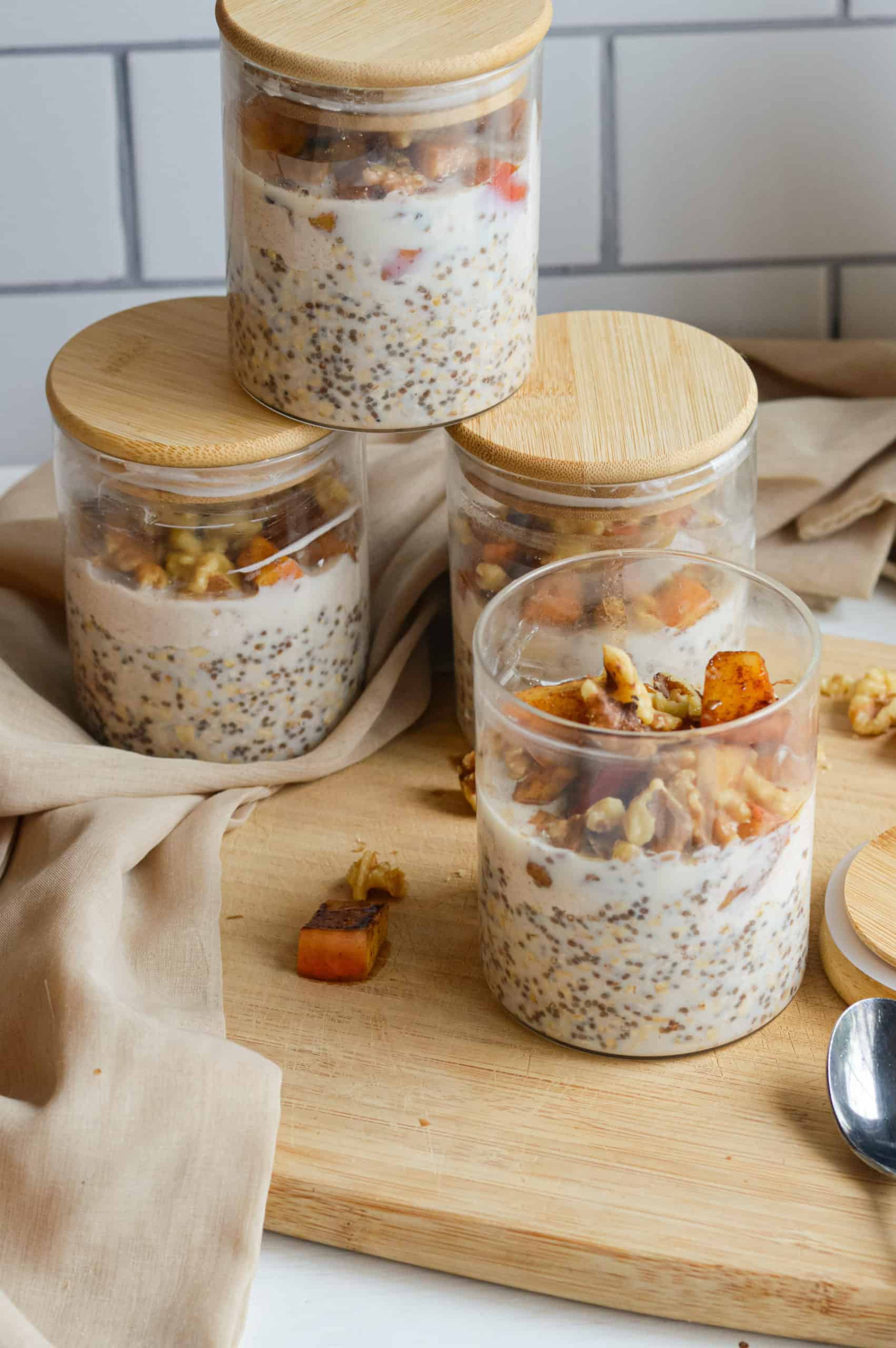 Stacked jars of apple pie overnight oats.