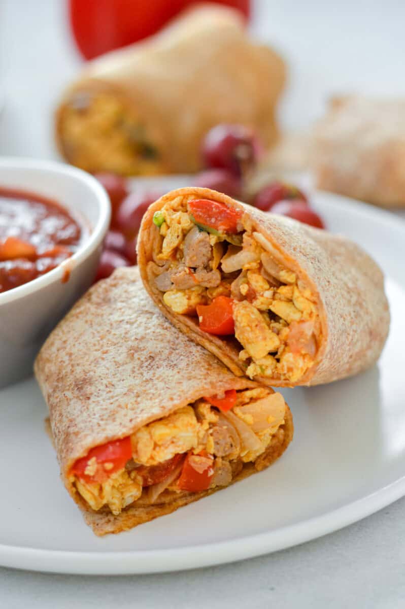 Breakfast burrito meal prep served with dipping sauce.