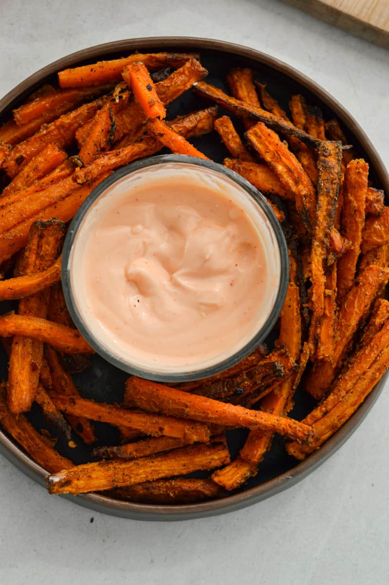 Birds eye of plate with crispy carrot fries and sriracha mayo.