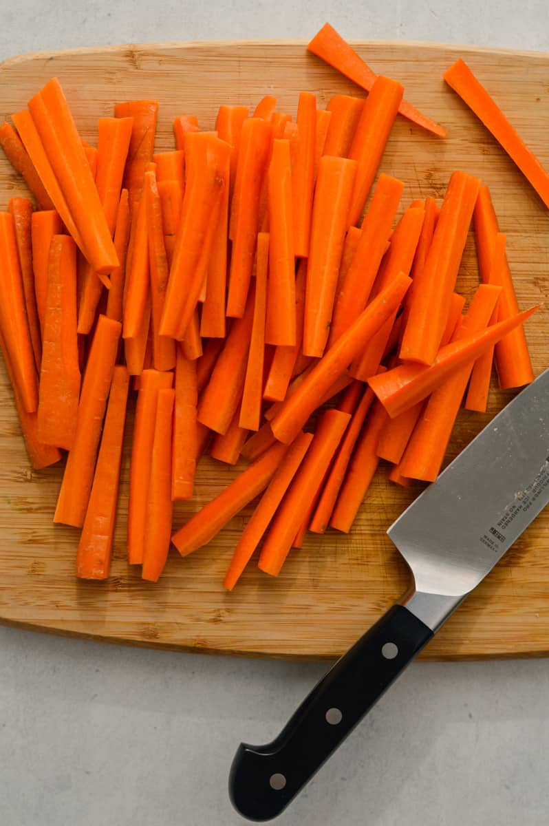 Cutting carrots into sticks.