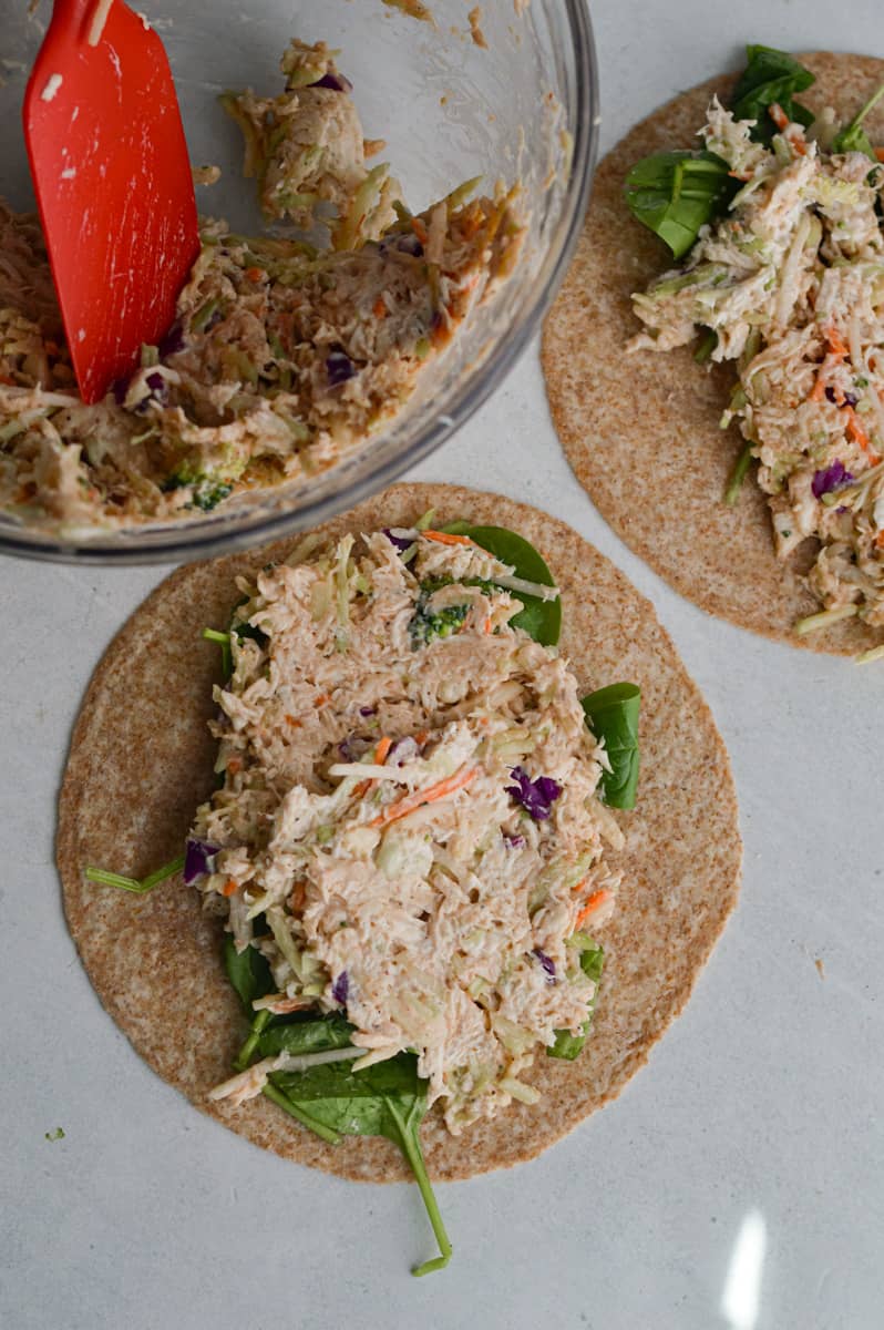 Adding 5 ingredient chicken salad recipe to whole wheat tortillas.