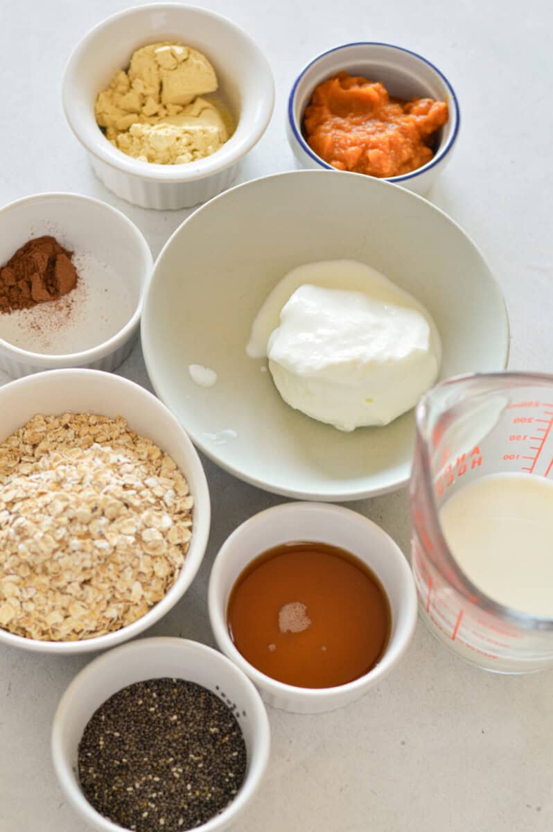 Ingredients including Greek yogurt, oats, milk, maple syrup, spices, pumpkin puree, protein powder.