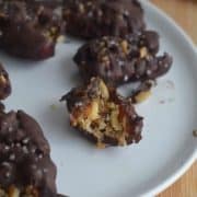 Chocolate covered dates on a plate.