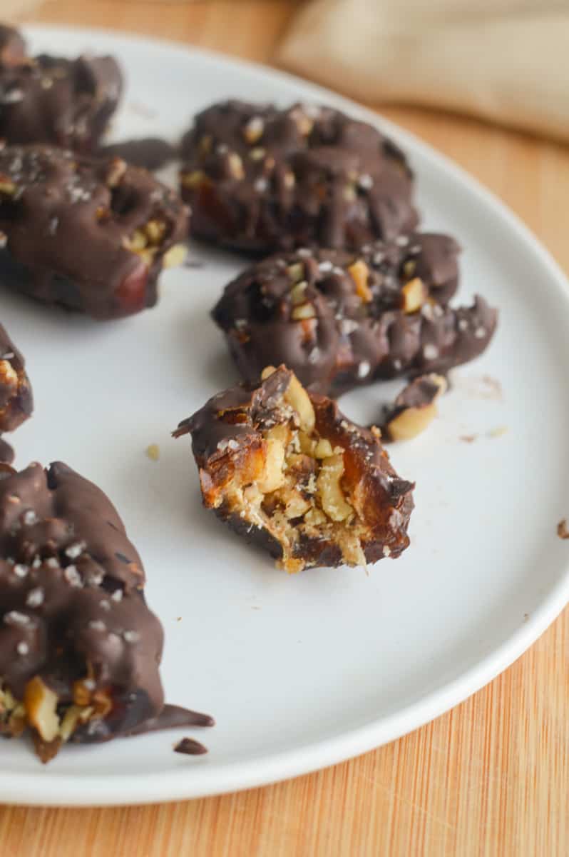 Chocolate covered dates on a plate.