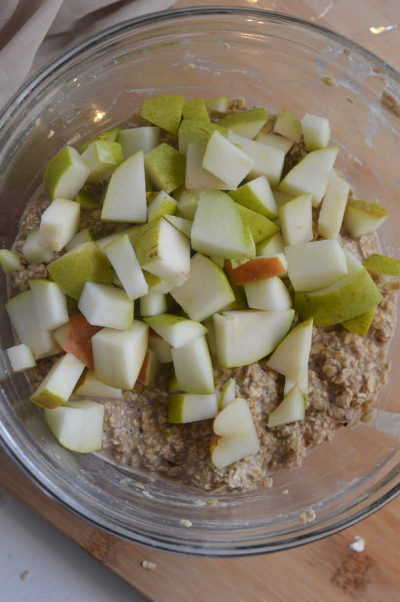 adding pears to the wet ingredients in the pear baked oatmeal