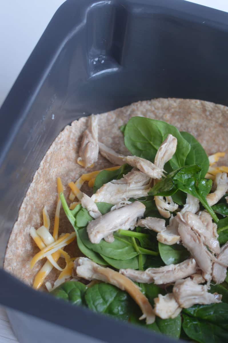 Cheese quesadilla in air fryer with toppings.