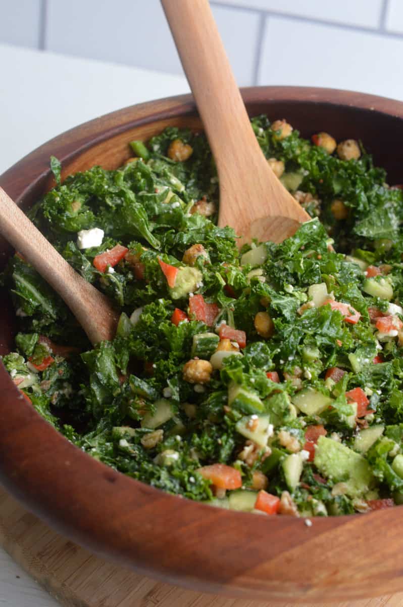 Tossing the dressing in tahini kale salad.
