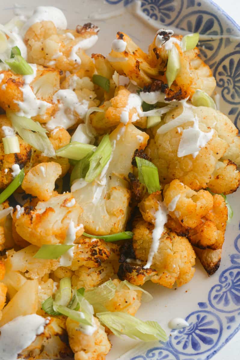 Air fryer frozen cauliflower with green onions and garlic aioli.