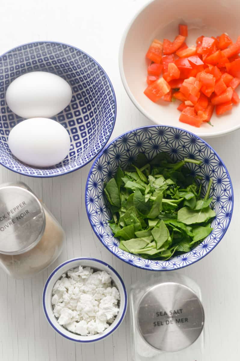 Birds eye view of ingredients for air fryer omelette including eggs, veggies, and cheese.