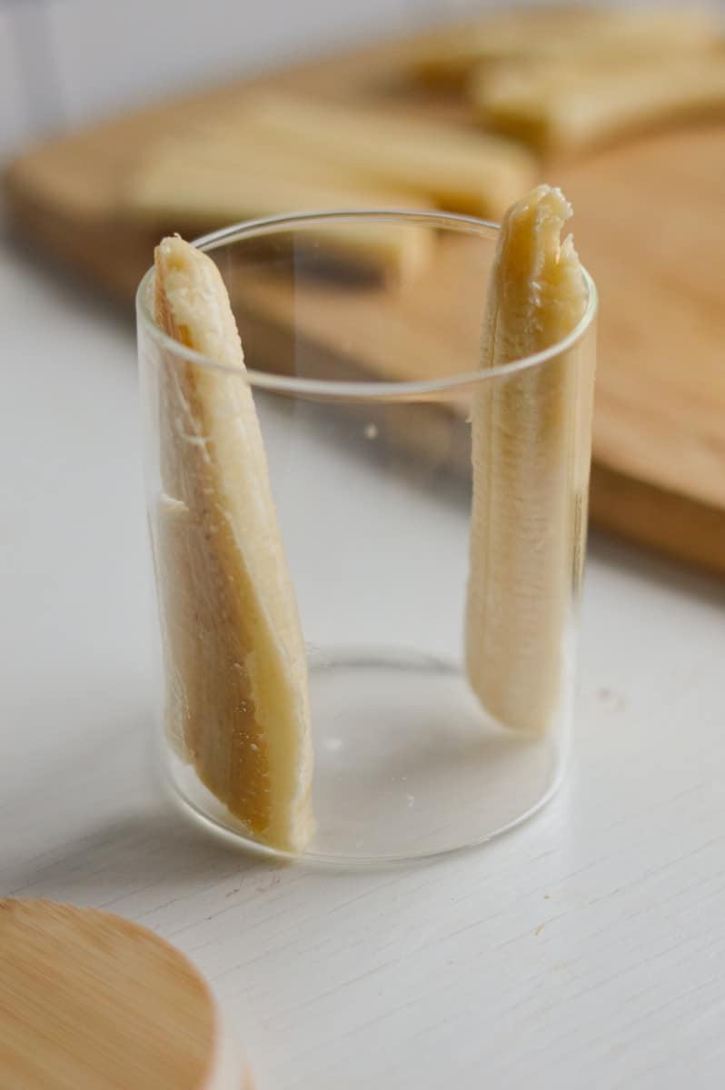Adding banana slices to jar.