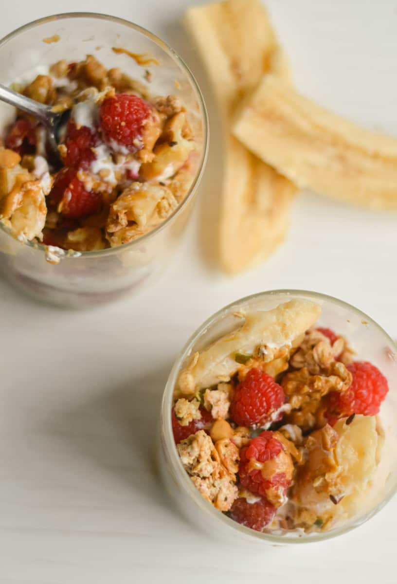 Birds eye view of Greek yogurt and granola banana split parfaits.