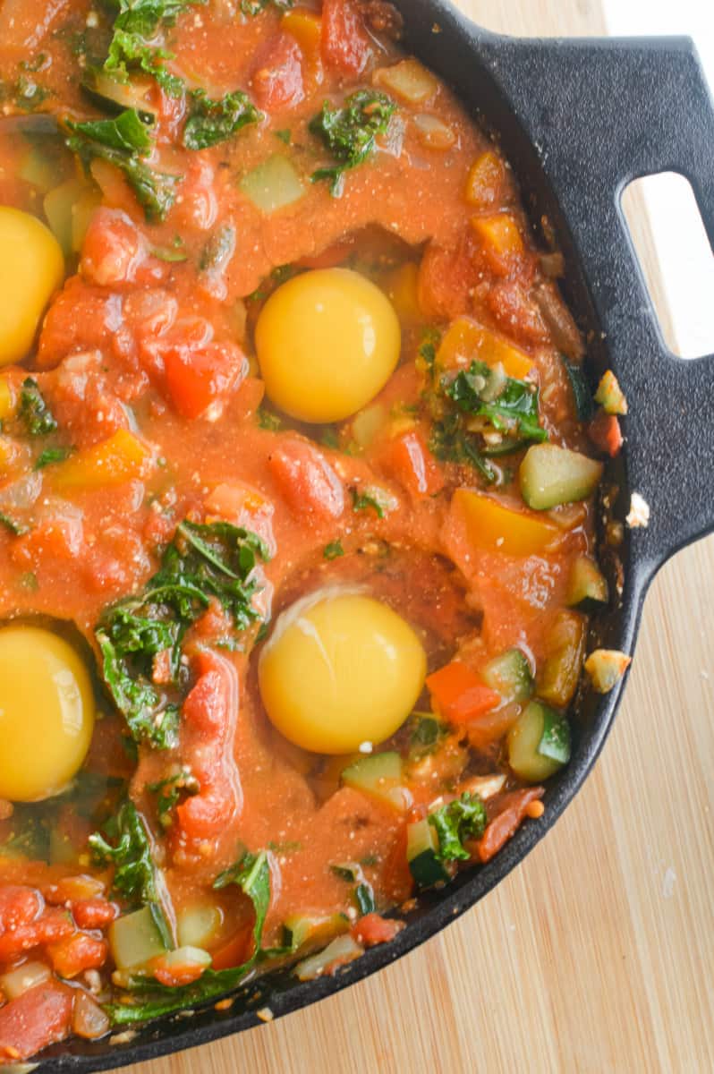 Cracking eggs into shakshuka.