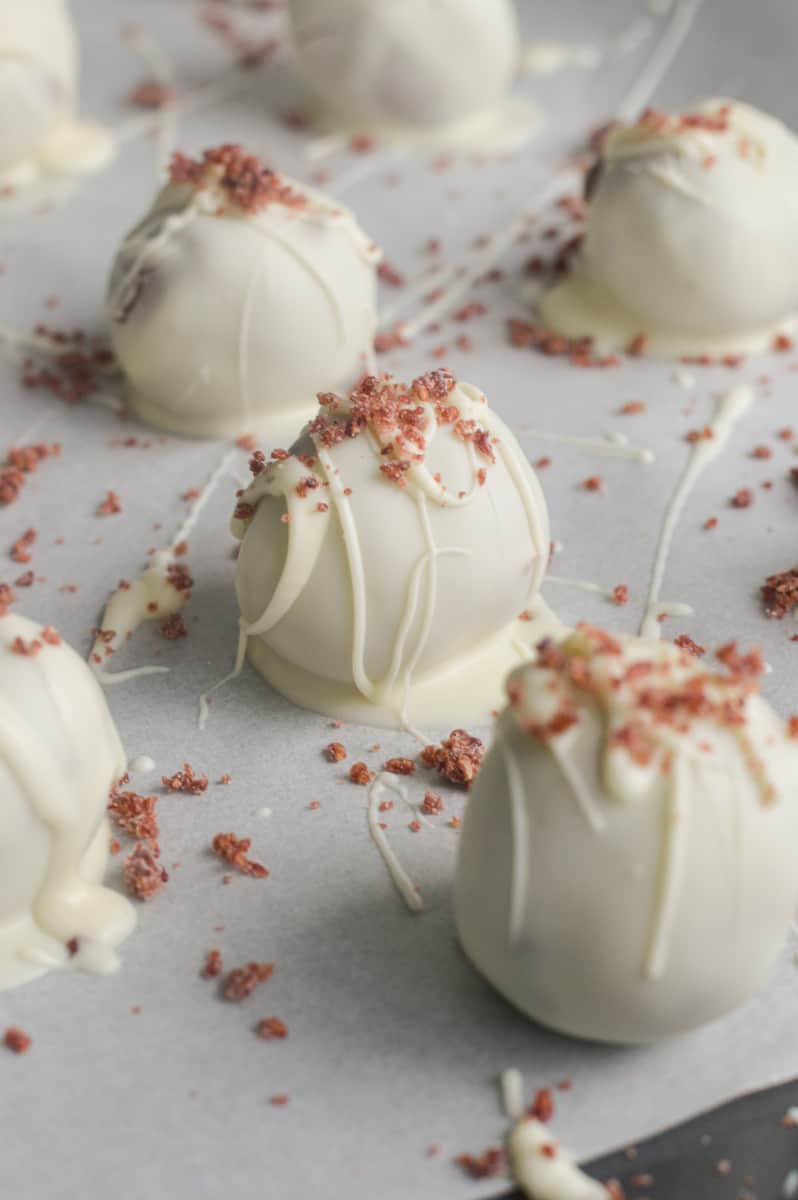 Dusting truffles with freeze-dried raspberry powder.