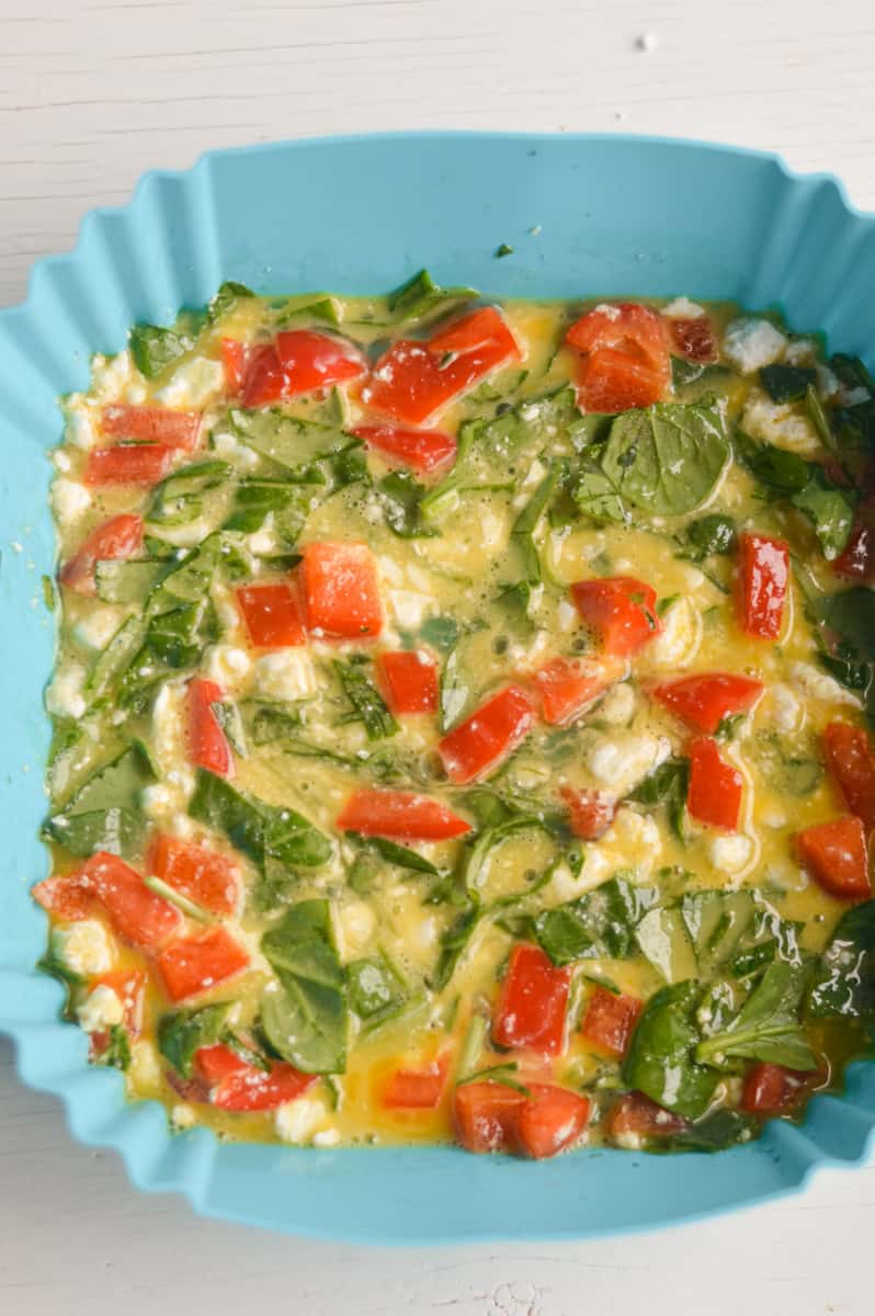 Eggs and mix-ins in air fryer liner.
