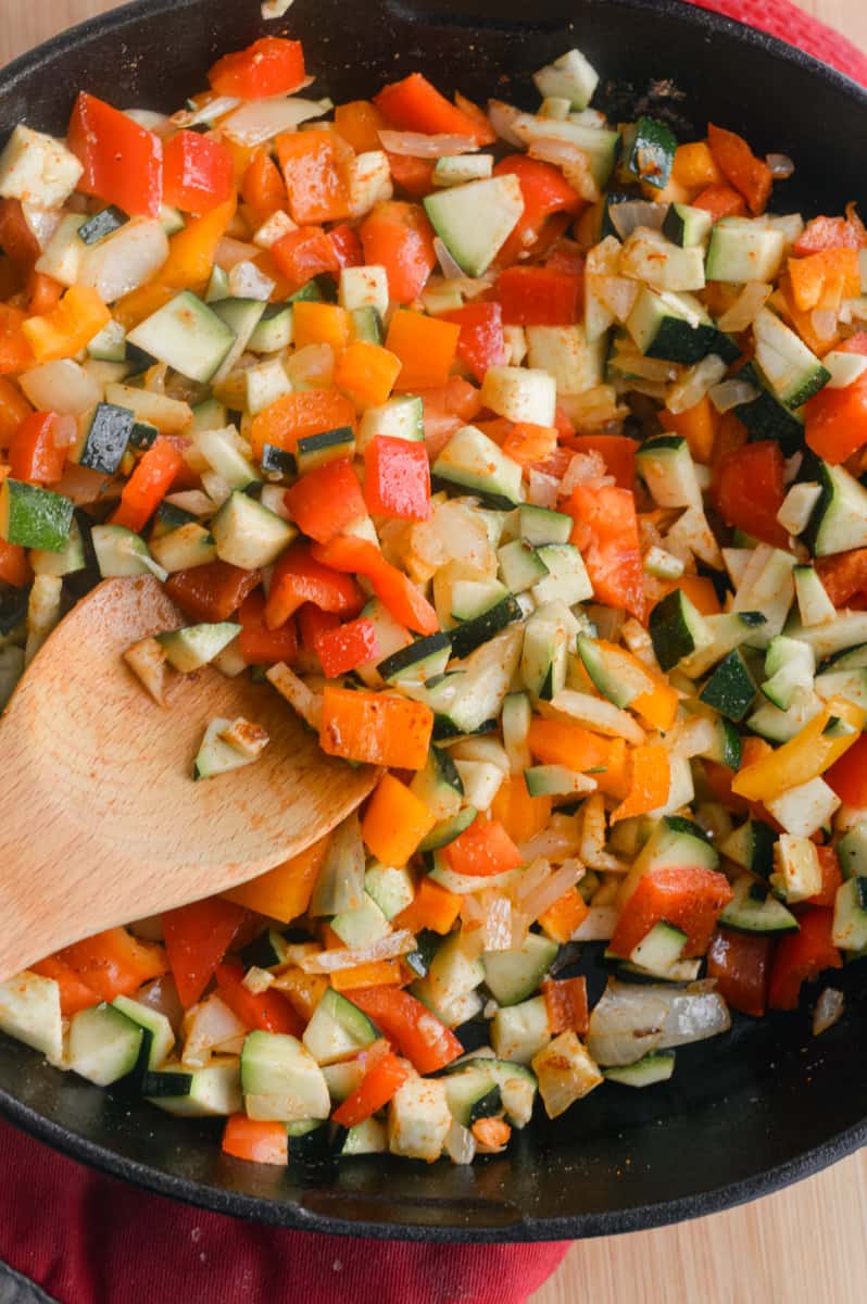 Stir-frying vegetables in a cast iron pan.
