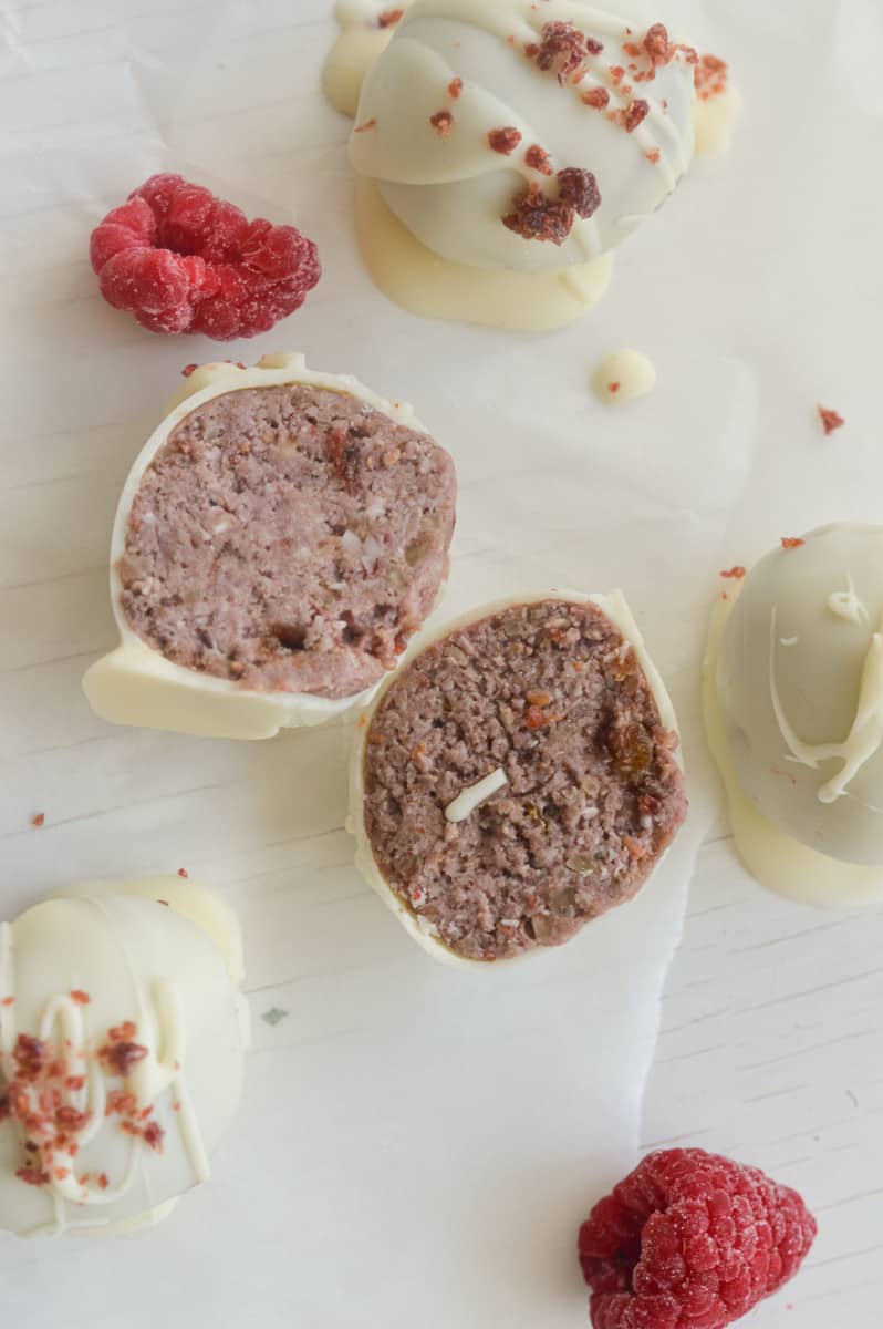White chocolate raspberry truffles sliced in half.
