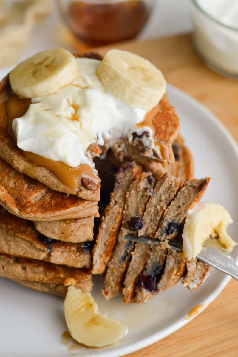 Cutting into a stack of 3 ingredient protein pancakes.