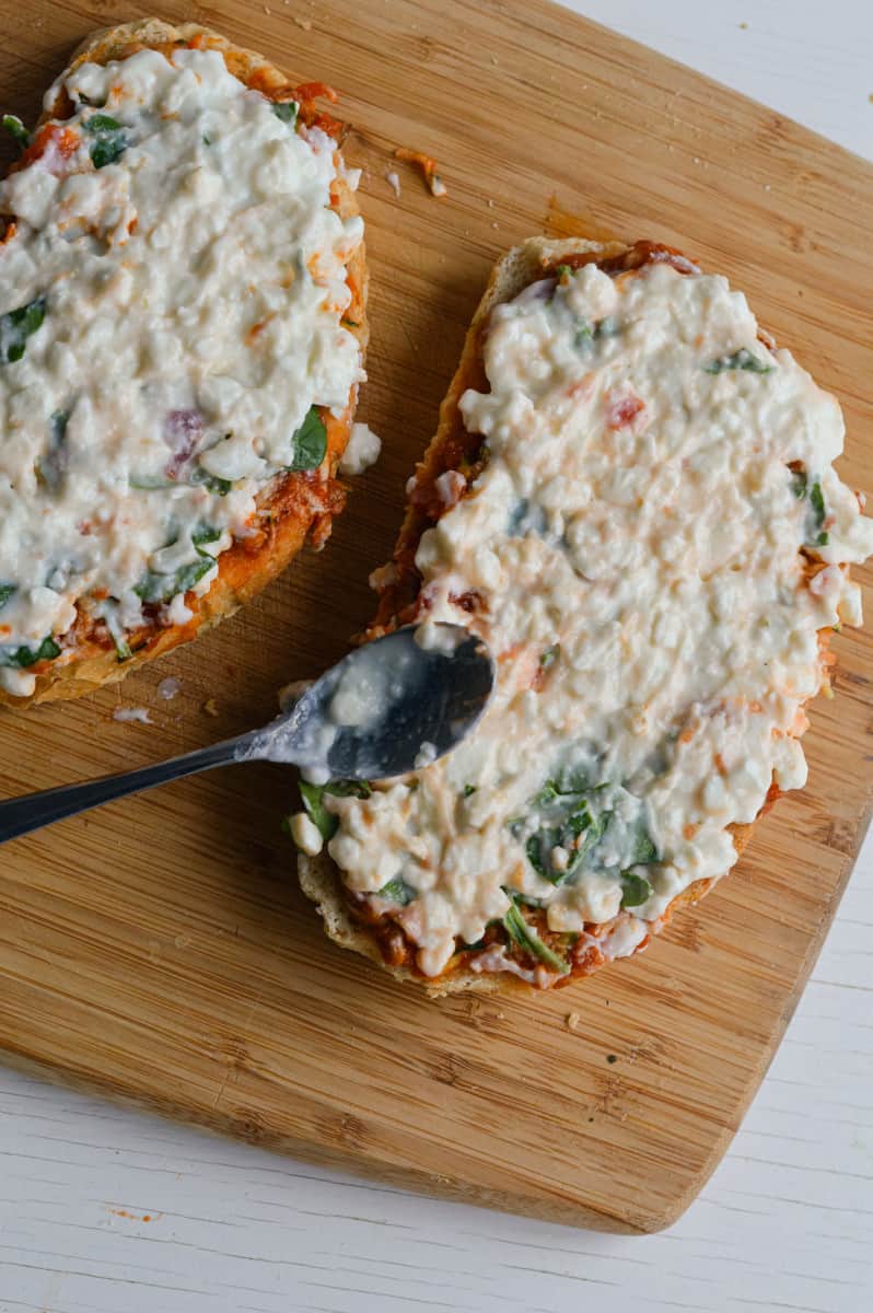 Adding cottage cheese on bread.