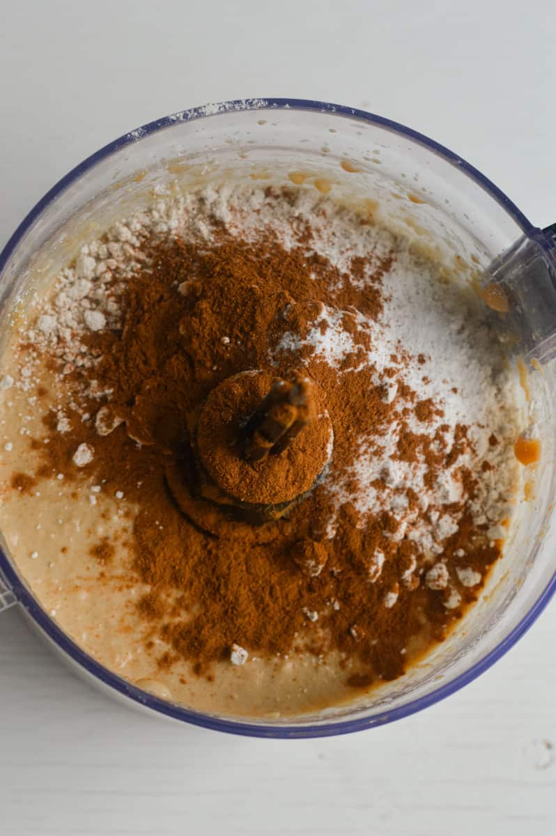 Adding ingredients to a food processor.