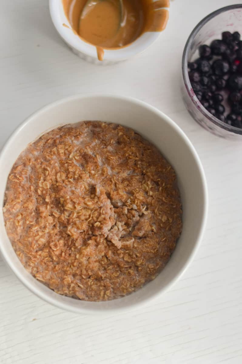 Adding toppings to egg white oatmeal.