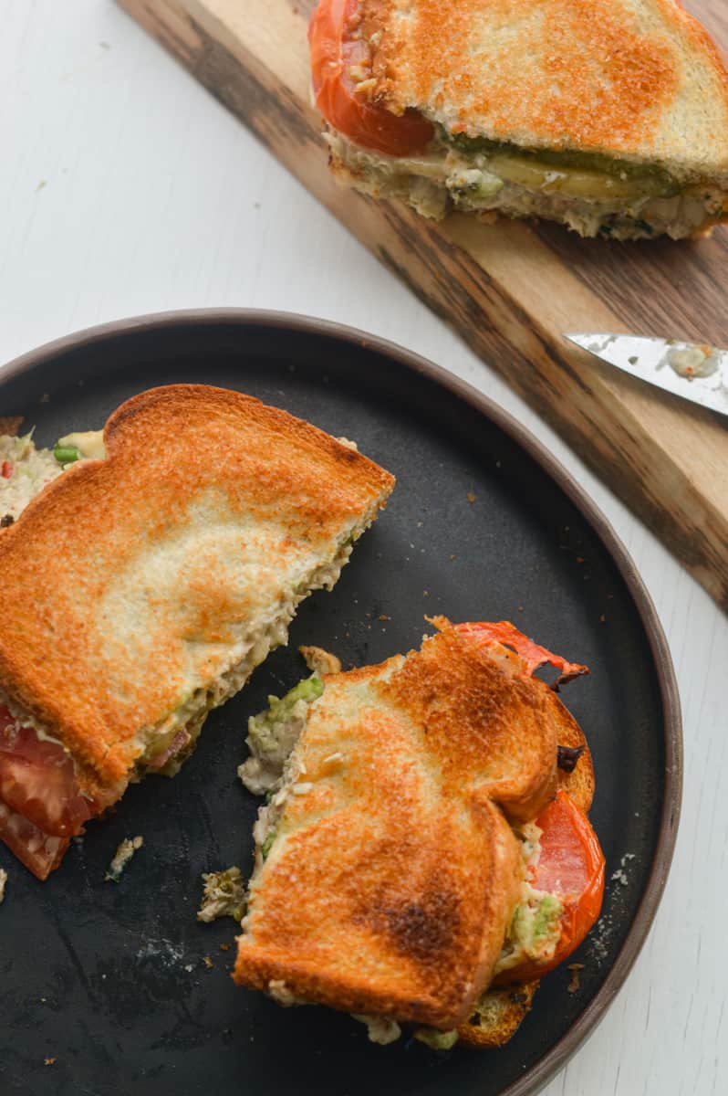 Air fryer tuna melt sliced in half on a plate.
