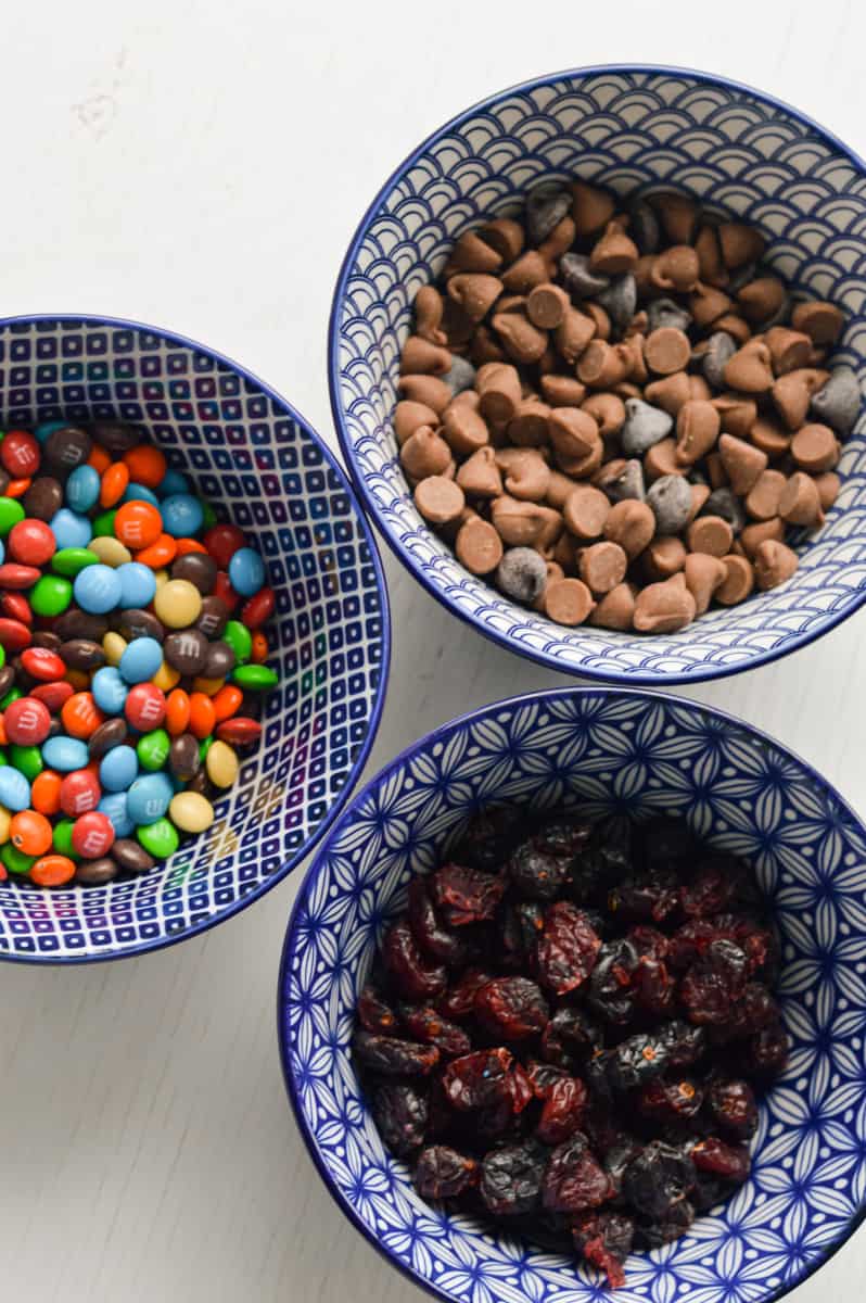 Mix-ins for oatmeal balls including chocolate chips, M&Ms and cranberries.
