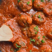 Close up of tofu meatballs in tomato sauce.